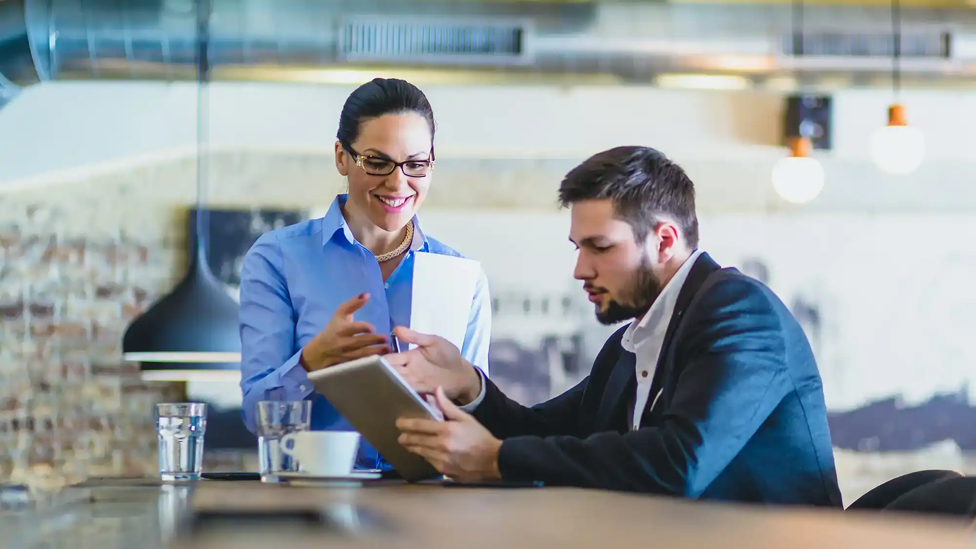 Lady and man at restaurant discussing business